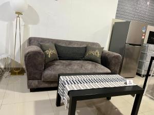 a living room with a couch and a coffee table at Cozy Studio Sk 1 Residence for 4 pax UPM Mines Serdang in Seri Kembangan