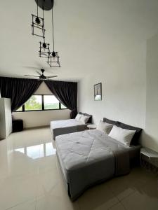 a bedroom with two beds and a large window at Cozy Studio Sk 1 Residence for 4 pax UPM Mines Serdang in Seri Kembangan