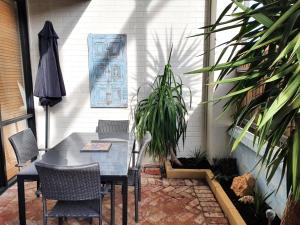 a table and chairs on a patio with plants at Primary 43 2BRM Townhouse Fremantle with 2 Carbays in Perth