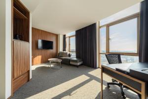a hotel room with a view of a living room at Staz Hotel Ulsan in Ulsan
