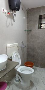 a bathroom with a toilet and a sink at Nivaant @ Vicharays in Alibaug