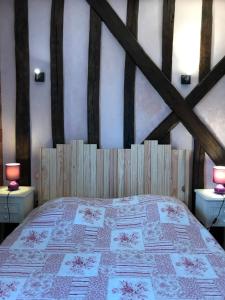a bedroom with a large bed with two tables at Au Milieu de Nulle Part, Chambres et gites écologiques au lac du Der in Outines