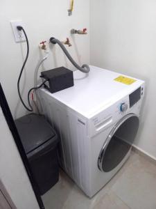 a washing machine in the corner of a room at Confortable depto con alberca in Zapopan