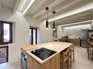 a kitchen with a large island with a counter top at Casa “Can Boira” in Valldemossa