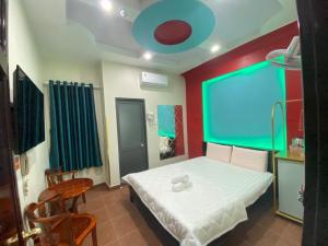 a bedroom with a bed and a large screen at HOTEL THU HÀ in Ho Chi Minh City