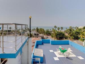 a patio with a table and chairs on a roof at Sycamore Residences in Mount Lavinia
