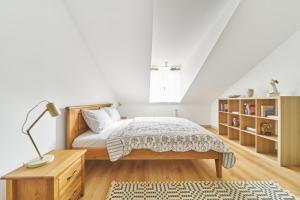 a bedroom with a bed and a desk with a lamp at Modern Two-Bedroom Apartment, Vilnius City Centre in Vilnius