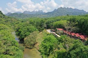 an aerial view of a resort with a river and mountains at Khao Sok River Home Resort in Khao Sok National Park