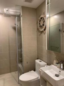 a bathroom with a toilet and a shower and a sink at A cozy condotel in Bai Sau(1 bed and 1 sofa bed) in Vung Tau