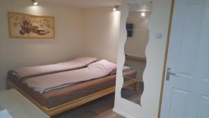 Posteľ alebo postele v izbe v ubytovaní Magnolia apartman