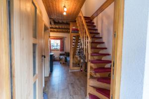 a hallway with wooden stairs in a house at Hike & Bike Chalet in Bohinj