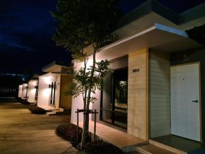 a building with lights on the side of it at night at Modern Resort in Ban Khlong Khachen