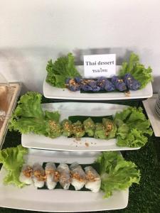 two plates of food with lettuce and sushi on them at Modern Resort in Ban Khlong Khachen