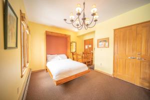 a bedroom with a bed and a chandelier at Black Bear 8035 in Keystone