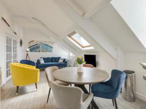 a living room with a table and chairs at Ocean View in Marazion
