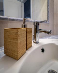 a bathroom sink with a wooden soap dispenser on it at Sea View Villa-Luxury Residence-Nature & Calm in Porto Heli