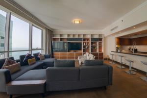 a living room with a couch and a bar at Al Bateen Residences, Jumeirah Beach Residence - Mint Stay in Dubai