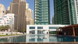 a large swimming pool in a city with tall buildings at Al Bateen Residences, Jumeirah Beach Residence - Mint Stay in Dubai