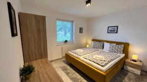 Un pat sau paturi într-o cameră la HausLipno