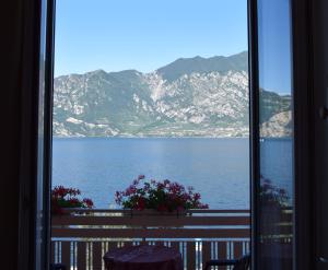 a view of the ocean from a room with a window at Hotel Vela Azzurra in Malcesine