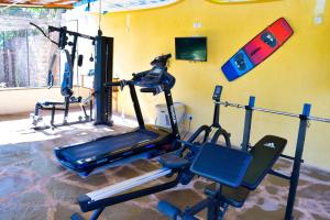 a room with a gym with two exercise bikes at Gästehaus Diani in Diani Beach