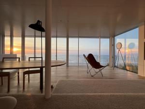 a dining room with a view of the ocean at Cliff House Morai in Ishikari +72 photos