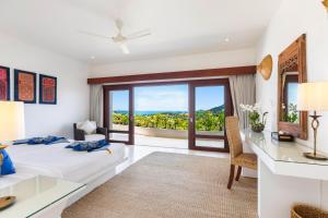 a bedroom with a bed and a desk with a view at Panorama Summit - Private Pool with Sunset View in Plai Laem +35 photos