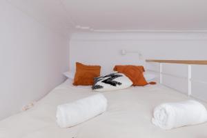 a white bed with pillows on top of it at City Centre & Cosy Apartment by Renters in Gdańsk