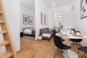 a living room with a table and a couch at City Centre & Cosy Apartment by Renters in Gdańsk