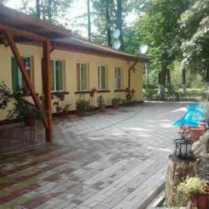 a house with a porch and a patio at Pensiunea Sub Stejari ! Self Service ! Cazare muncitori Câmpina ! Workers team accommodation ! in Băneşti