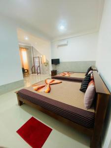 a bedroom with a large bed in a room at Optimum Residencies in Negombo