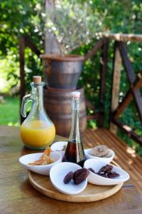 a table with a plate of food and a bottle of juice at La Belle Rivière in Bolozon