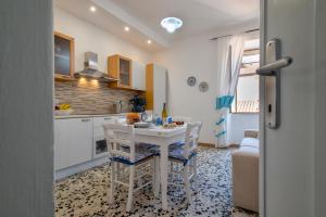 a kitchen with a table and chairs in a room at Casa Vacanze San Michele in Alghero