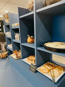 a bakery with shelves filled with different types of bread at Vini Hotel in Beaune