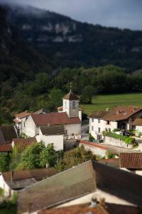 a small village with a church in the distance at La Belle Rivière in Bolozon +2 photos
