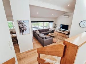 a living room with a couch and a tv at Sea Haven in Rye