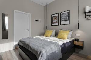a bedroom with a large bed with yellow pillows at NN Urban Guesthouse in Reykjavík