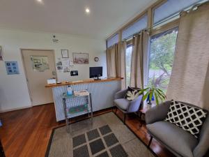 a room with two chairs and a desk with a computer at Park Drive Motel in Kempsey