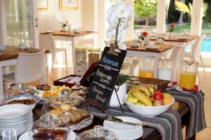a table with a buffet of food on it at Wild Olive Guest House & Villa in Cape Town +57 photos
