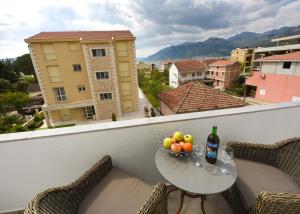 a table with a bowl of fruit on a balcony at Sea Point II Apart hotel Tivat in Tivat
