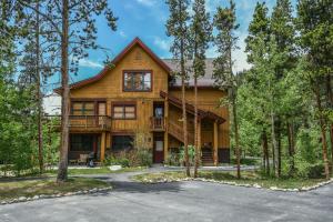 a large wooden house with a lot of trees at Trappers Crossing 8753 in Keystone