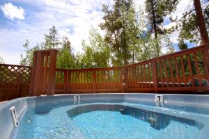 a hot tub on the back of a deck at Trappers Crossing 8753 in Keystone
