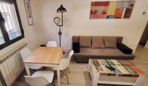 a living room with a table and a couch at www Goyahospitales es in León