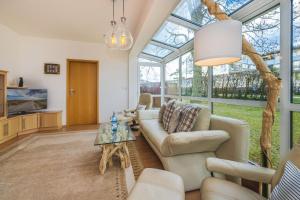 a living room with a couch and a table at Haus Strandoase 27 in Bansin