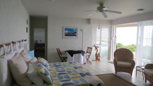 a bedroom with a bed and a table and chairs at At the Beach in Jeffreys Bay