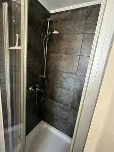 a bathroom with a shower with a bath tub at Ferienwohnung Christa in Bullay +24 photos