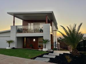 a modern house with a balcony in a yard at If you are looking for iconic modern, look no further in San Remo
