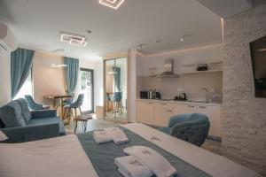 a hotel room with a bed and a kitchen at Lazar Lux Suites - Ammoudara in Agios Nikolaos