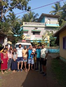 a group of people posing for a picture on a street at NISARG HOME STAY near Bus Stand Malvan in Malvan