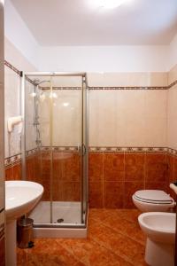 y baño con ducha, aseo y lavamanos. en Corcioli B&B, en Mesagne